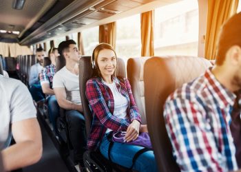 Hipster Passengers Have Music Read in Travel Bus.